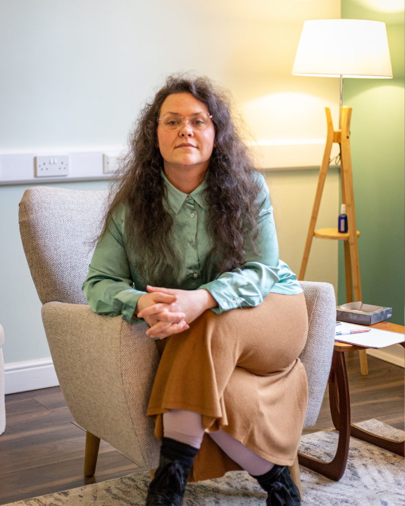 Elena kormalou psychotherapist and coach sitting in Chalice therapy room in hebden bridge